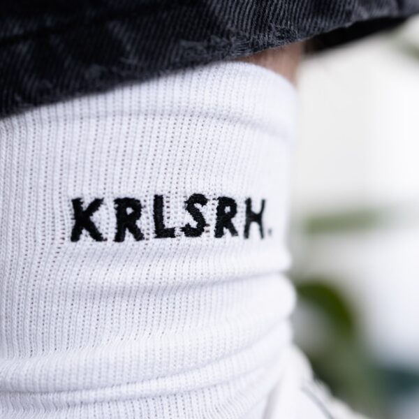 Weiße Socken bestickt mit schwarzem KRLSRH Motiv