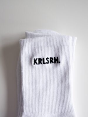 Weiße Socken bestickt mit schwarzem KRLSRH Motiv